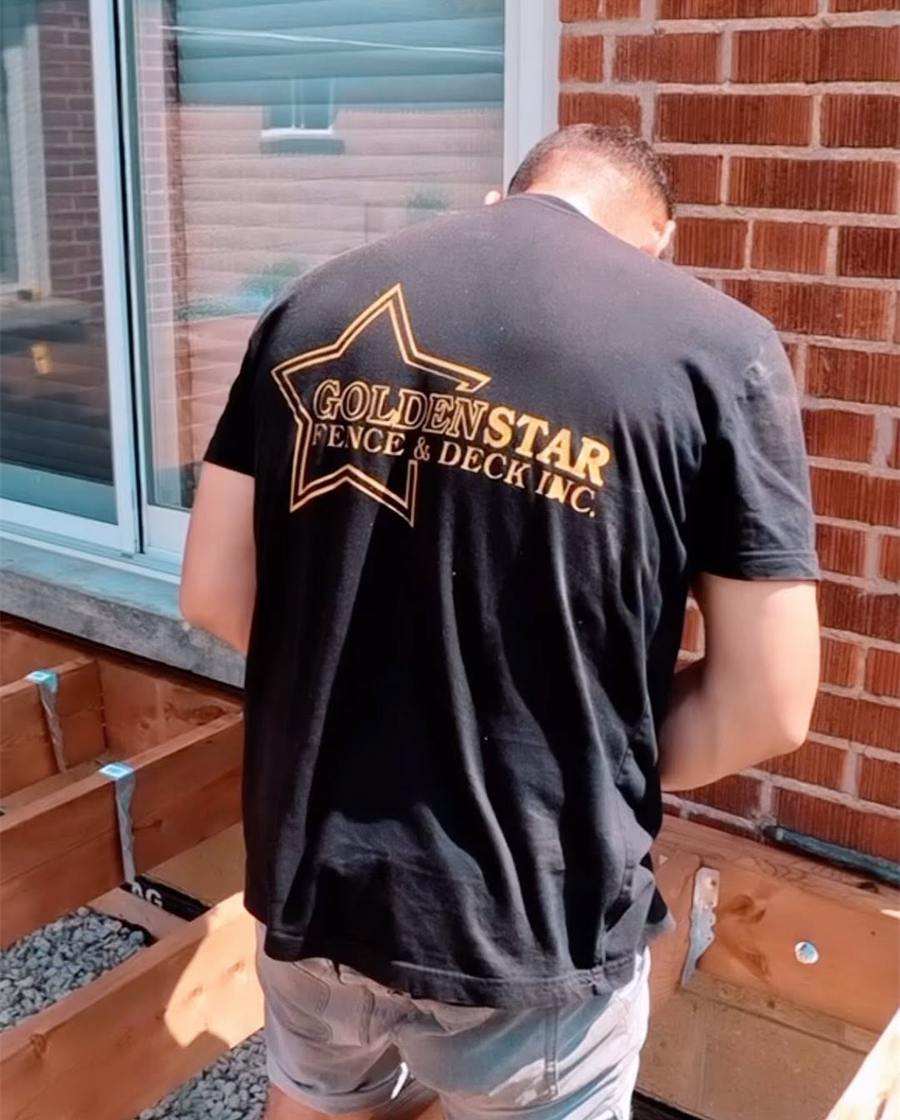 Framing a new deck beside a brick house